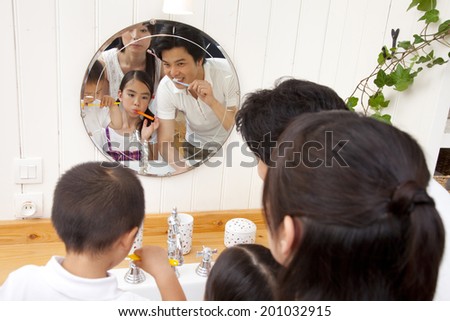 Family brushing their teeth