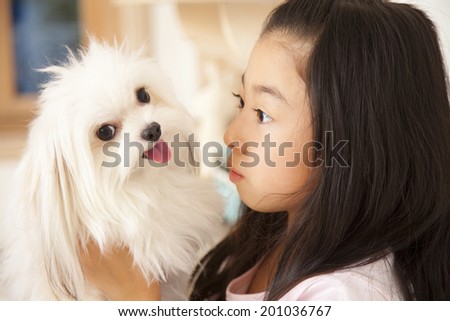 smiling girl staring at a puppy