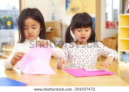 girls folding origami