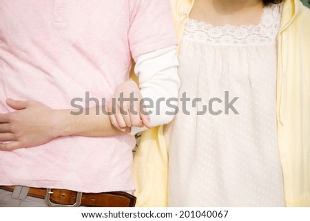 Men and women arm in arm