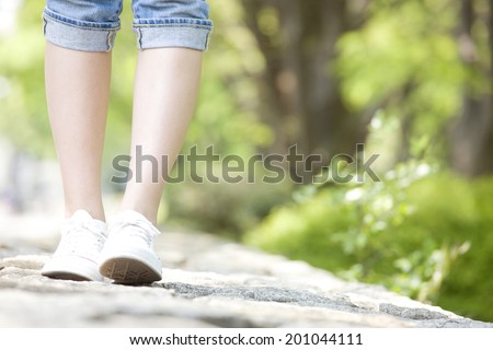 The feet of the woman taking a walk