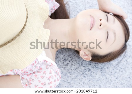 The woman taking a nap on a bench