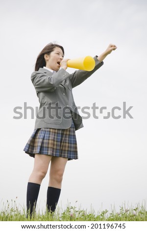 The high school girl cheering with megaphone