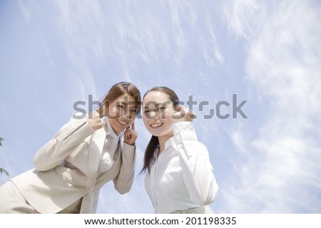 Two women taking victory poses