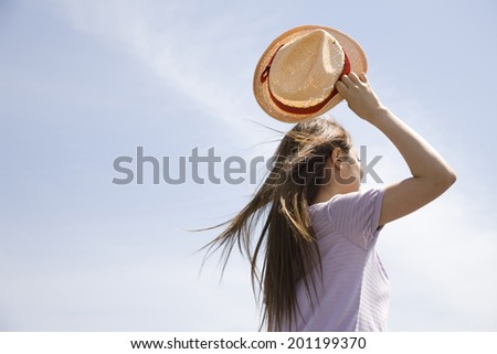 Back figure of women who are taking the hat