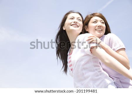 Two laughing women while playing each other