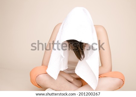 The woman putting a towel on her head