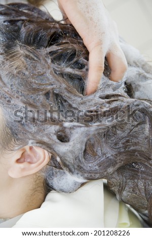 The hand of the hairdresser washing the hair of a women