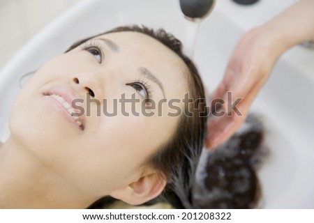 The woman washing her hair in salon