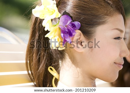 The profile of the relaxing woman sitting on the deck chairs on the beach