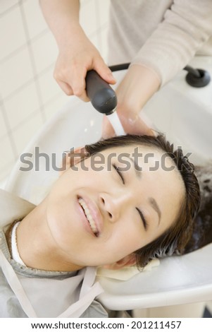 The woman washing her hair in salon