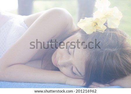 The woman lying down on a bench
