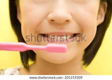 The mouth of the girl brushing her teeth