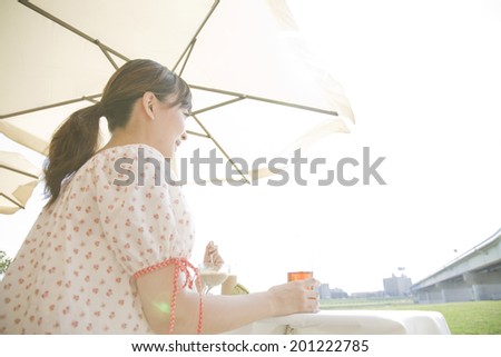 The woman drinking tea in open cafe