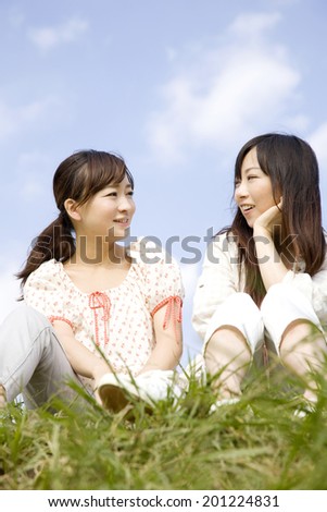 Two women sit down to talk in the hills