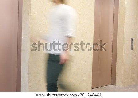 The man walking in front of the elevator