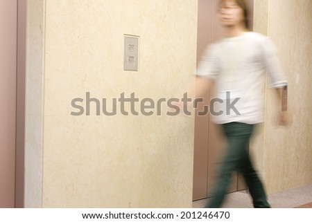 The man walking in front of the elevator