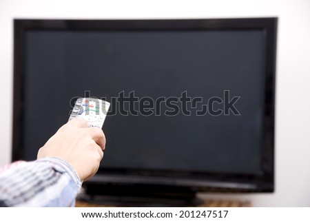 The hand of the man with a remote control