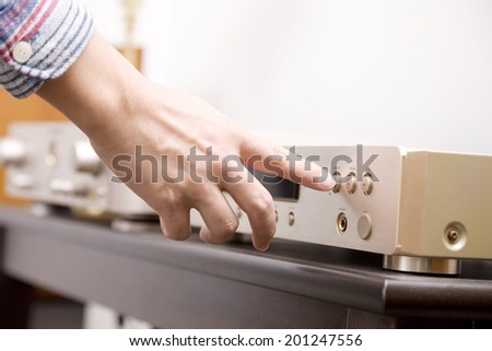 The hand of the man inserting the CD