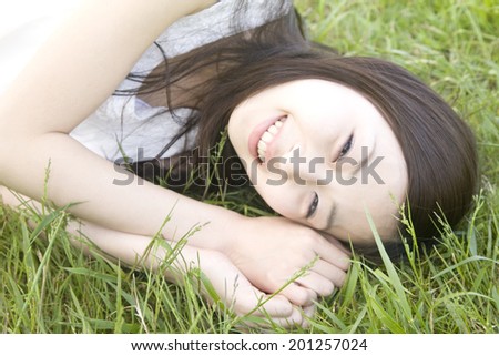 Women lie down on a lawn