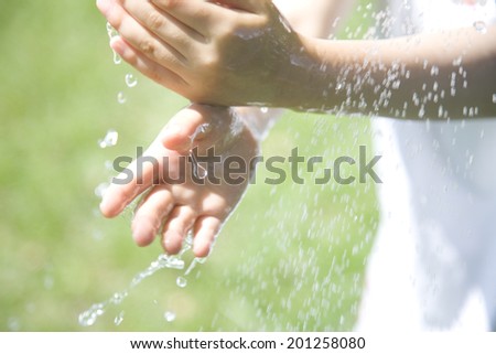 The hands of a girl washing her hands