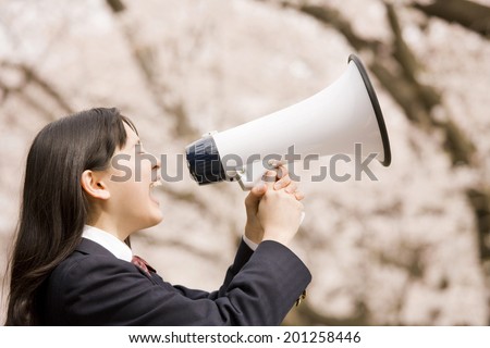 A middle school girl screaming through a megaphone