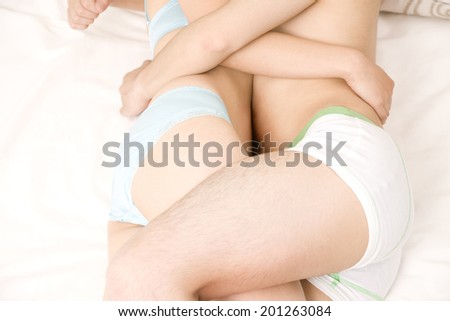 A Couple hugging each other in bed