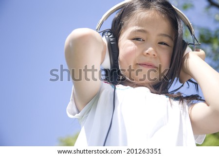 A girl listening to music with headphones