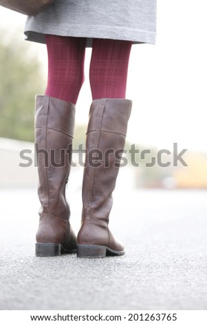 The legs of the woman wearing boots