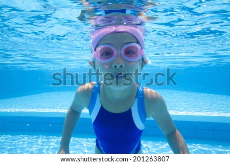 Girl swimsuit diving into water
