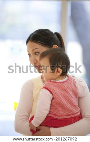 Nursery school girls hugging with a nursery