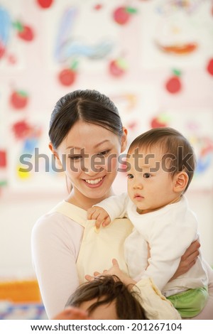 Nursery school boy hugging with a nursery