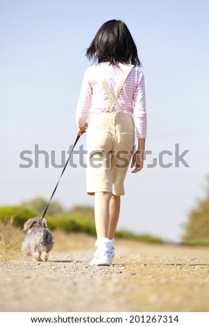 back of the girl walking with miniature wire head