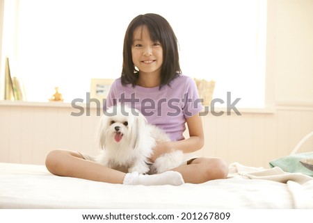 puppy sitting on the knee of a girl