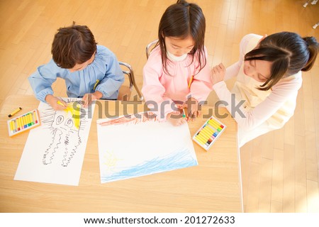 Kindergarten teachers watching the kindergarten children enjoying drawing