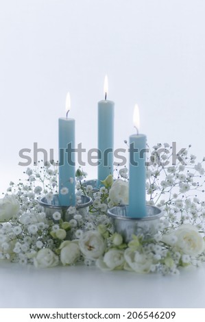 Flower Arrangment Of The White Flower And The Blue Candle