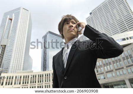 Business Man Speaking Into Cell-Phone
