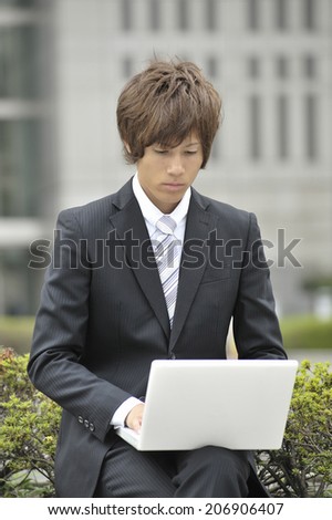 Business Man Using Notebook Pc In The Outdoor