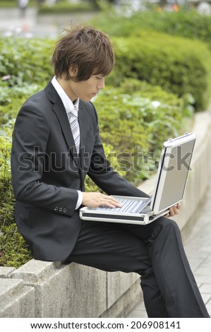Business Man Using Notebook Pc In The Outdoor