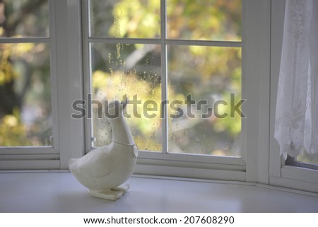 The White Window-Side And A Wooden Duck In Autumn
