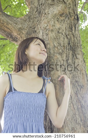 The Woman Leaning Against A Tree