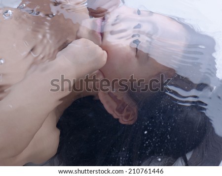 Girl Pinching Her Cheek Underwater