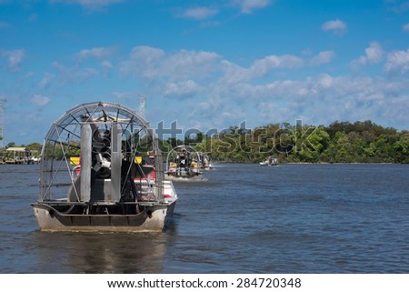 Airboats with tourists leaving on guided tour through Louisiana swamps