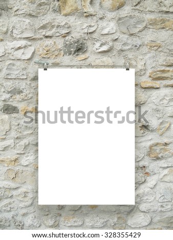 One hanged paper sheet with clothes hanger on medieval stone wall background