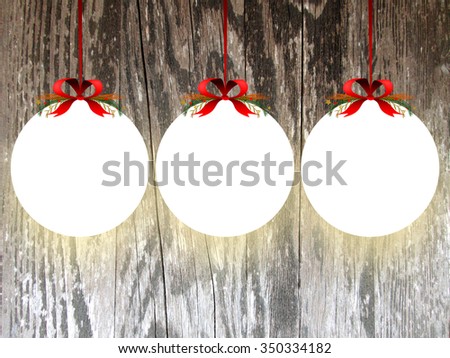 Three empty illuminated circle frames with Xmas ribbon decoration on brown wooden boards background