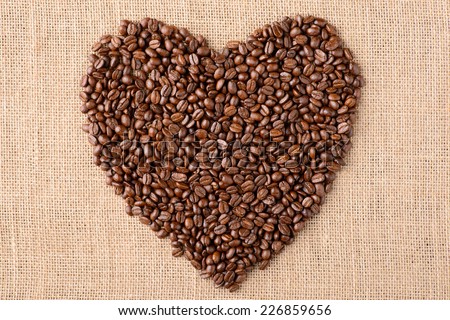 Heart coffee frame made of coffee beans on burlap texture