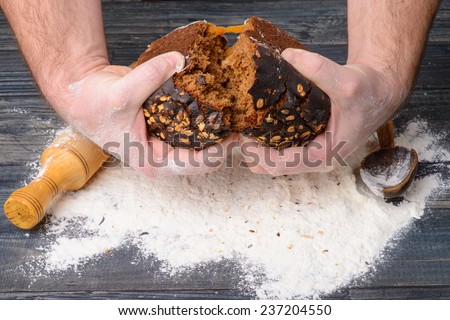 black bread in male hands chef