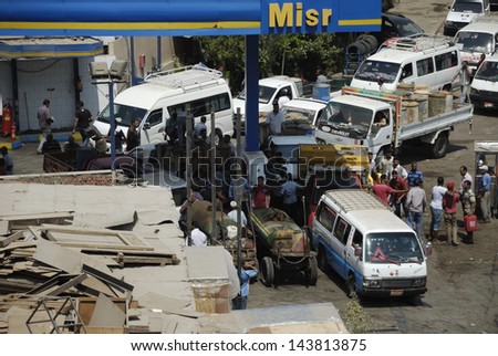 CAIRO - JUNE 27: Crowds in MISR petroleum station, where vehicles and unidentified people hold empty tanks to get 80 octane fuel in Maadi, Cairo, Egypt. June 27, 2013
