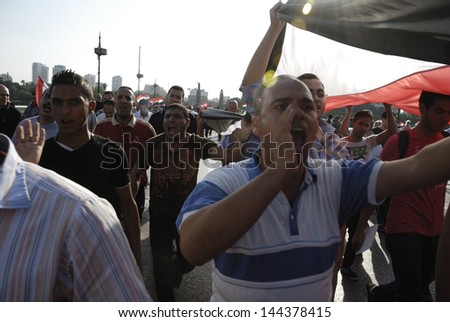 CAIRO - JUNE 30: Unidentified anti Muslim Brotherhood/Morsi protesters over Qasr el-Nil bridge shout slogans calling for Morsi\'s resignation on June 30, 2013 in Cairo, Egypt.