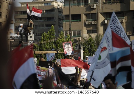CAIRO - JUNE 21: \'el wasat\' party raise signs against violence in Rabaa el-Adawya gather in Nasr City to support the president Morsi in the event titled \